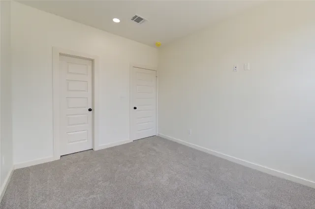 an empty room with closet area