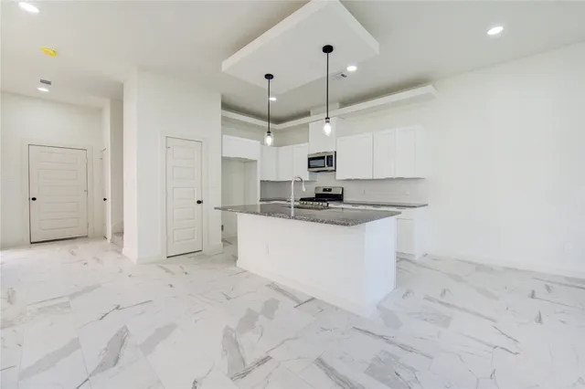 a view of kitchen with white cabinets