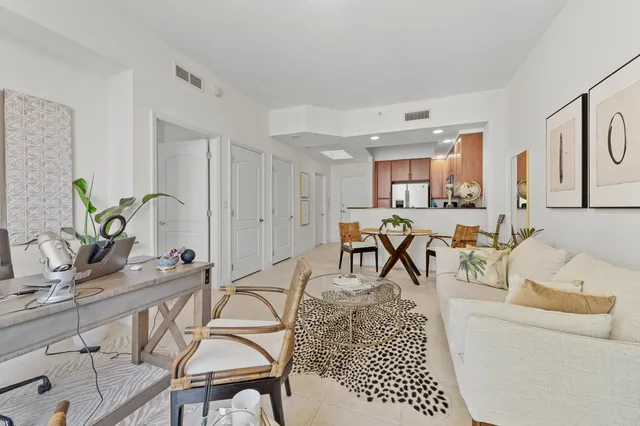 a living room with furniture a dining table and chairs