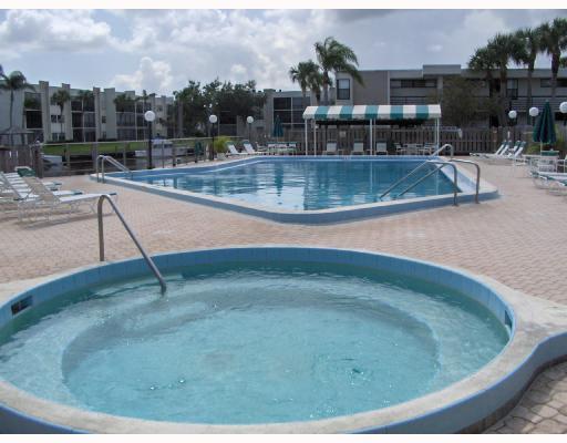 1950 Southwest Palm City Road, Unit 9104 Stuart, FL 34994 - Photo 7 of 8 a view of outdoor space swimming pool and seating