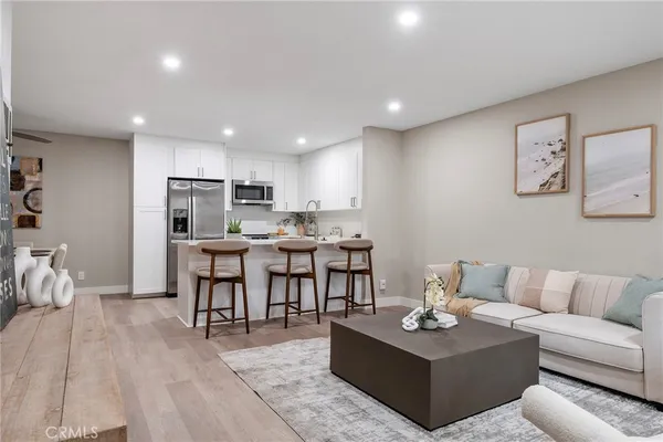 a living room with furniture and view of kitchen