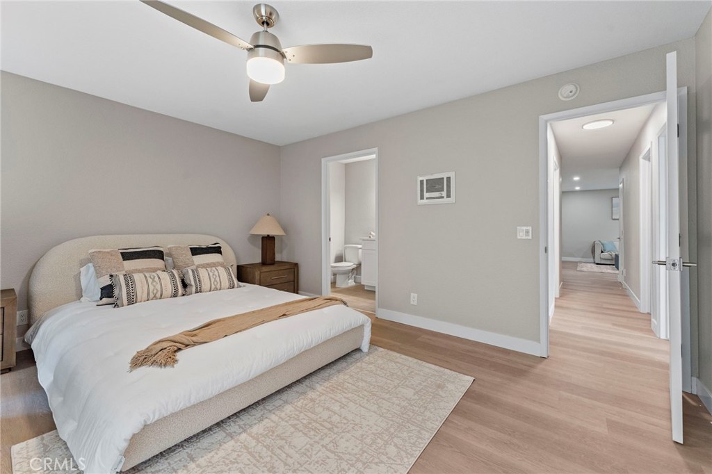 664 Tamarack Avenue, Unit 6 Carlsbad, CA 92008 - Photo 15 of 23 a bedroom with a large bed and ceiling fan