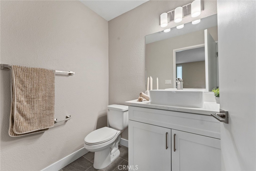 664 Tamarack Avenue, Unit 6 Carlsbad, CA 92008 - Photo 16 of 23 a bathroom with a toilet sink and mirror