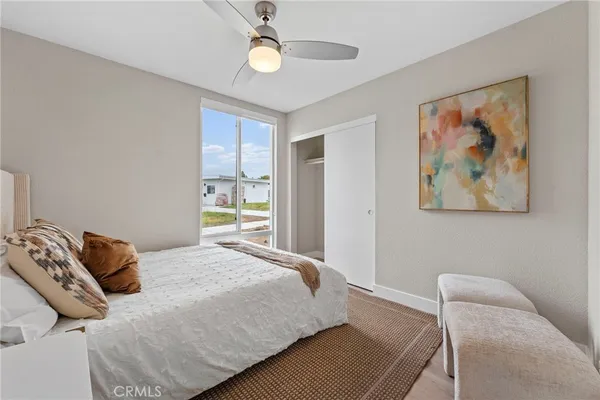 a bedroom with bed and a window