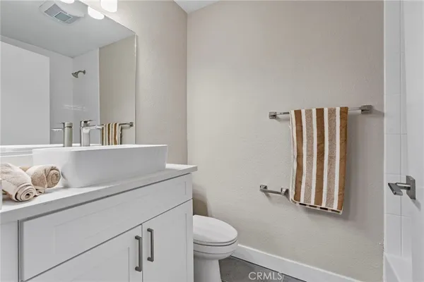a bathroom with a sink a toilet and a mirror
