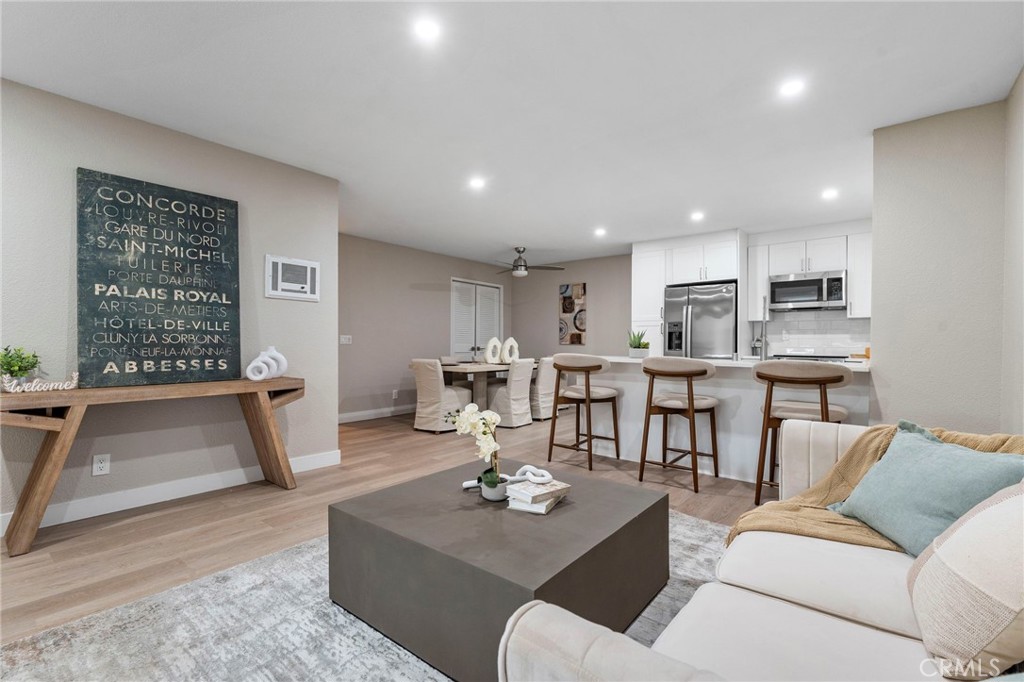 664 Tamarack Avenue, Unit 6 Carlsbad, CA 92008 - Photo 5 of 23 a living room with furniture and a large window