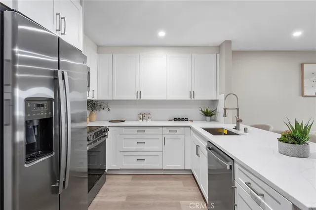 a kitchen with a sink stainless steel appliances and cabinets