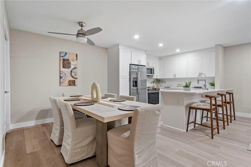 664 Tamarack Avenue, Unit 6 Carlsbad, CA 92008 - Photo 8 of 23 a open dining room with stainless steel appliances kitchen island a table and chairs