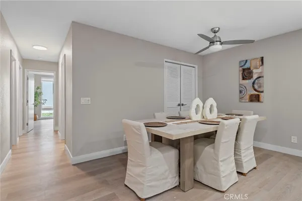 a view of a dining room with a table and chairs