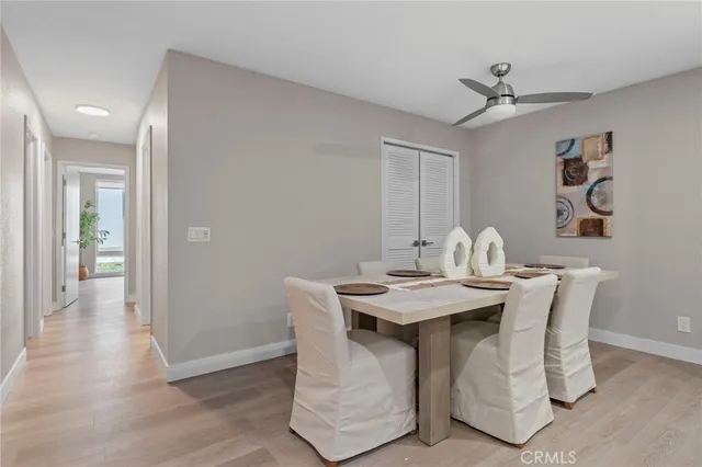 a view of a dining room with a table and chairs