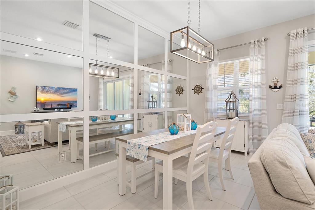 2516 Coral Court Indian Rocks Beach, FL 33785 - Photo 11 of 69 a view of a dining room with furniture a chandelier and wooden floor