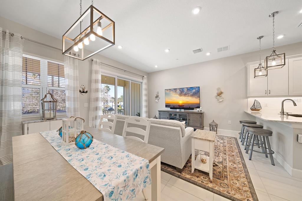 2516 Coral Court Indian Rocks Beach, FL 33785 - Photo 13 of 69 a living room with dining table furniture and a chandelier