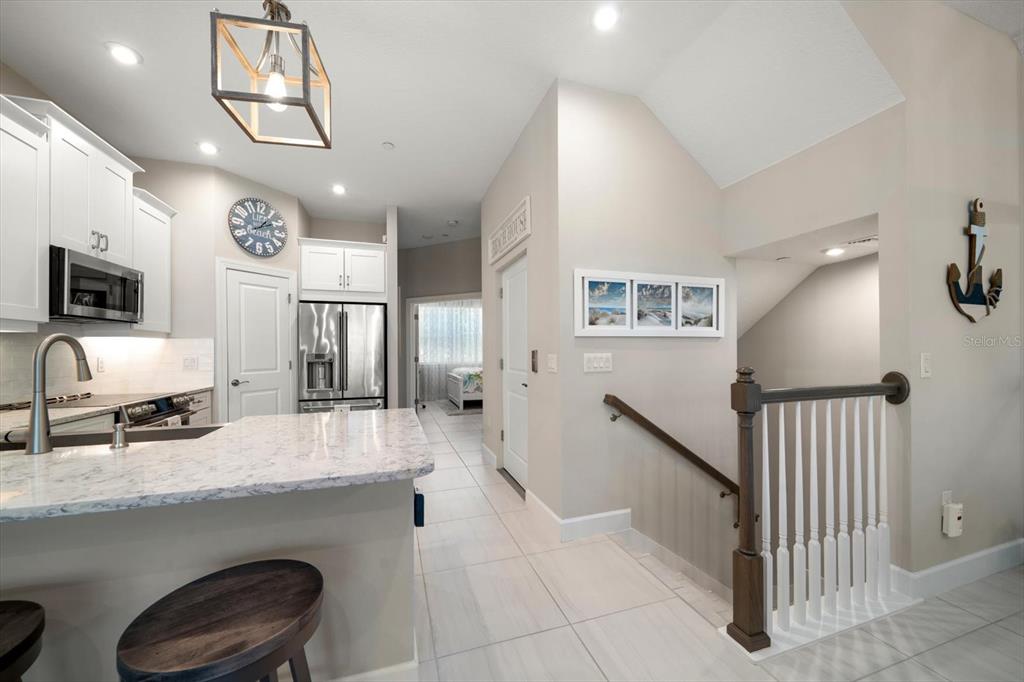 2516 Coral Court Indian Rocks Beach, FL 33785 - Photo 16 of 69 a en suite bathroom with a granite countertop sink and a mirror