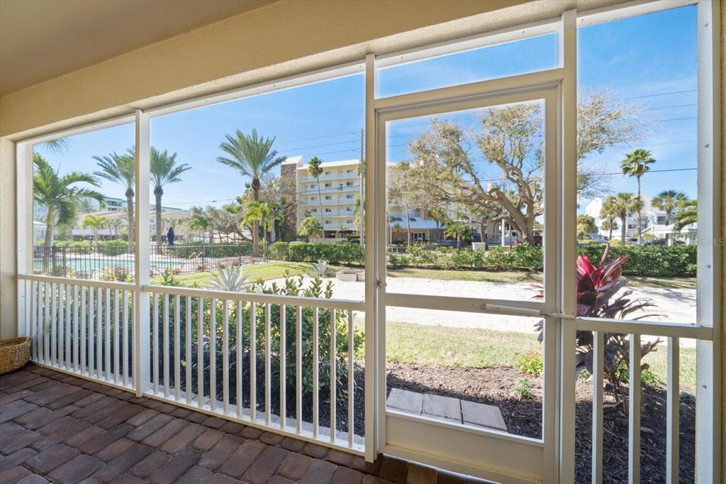 2516 Coral Court Indian Rocks Beach, FL 33785 - Photo 30 of 69 a view of a porch with a floor to ceiling window next to a yard