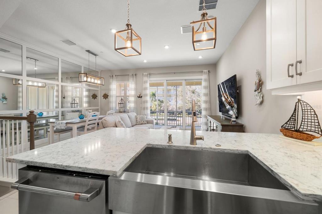 2516 Coral Court Indian Rocks Beach, FL 33785 - Photo 37 of 69 a kitchen with granite countertop a sink a counter top space appliances and cabinets