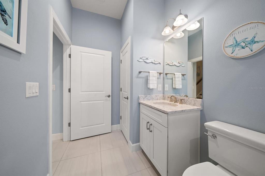 2516 Coral Court Indian Rocks Beach, FL 33785 - Photo 41 of 69 a bathroom with a granite countertop sink a toilet and a mirror