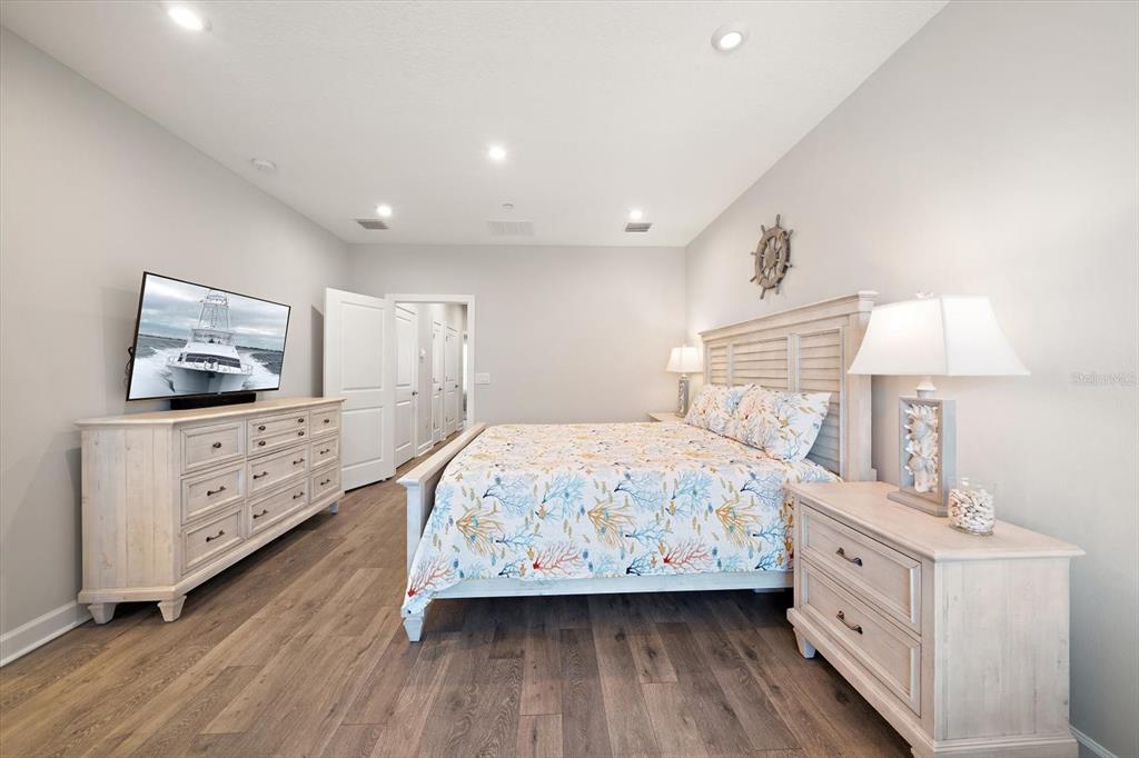 2516 Coral Court Indian Rocks Beach, FL 33785 - Photo 45 of 69 a bedroom with a bed and a flat tv screen on dresser