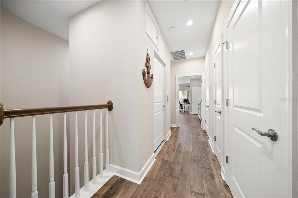 2516 Coral Court Indian Rocks Beach, FL 33785 - Photo 53 of 69 a view of a hallway with wooden floor and staircase