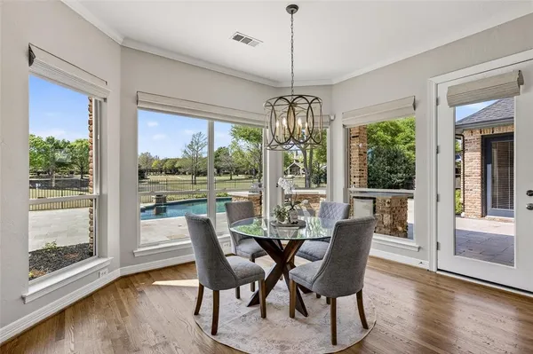 a view of a dining room with furniture large windows and wooden floor