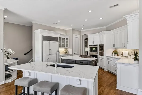 a large kitchen with a table and chairs