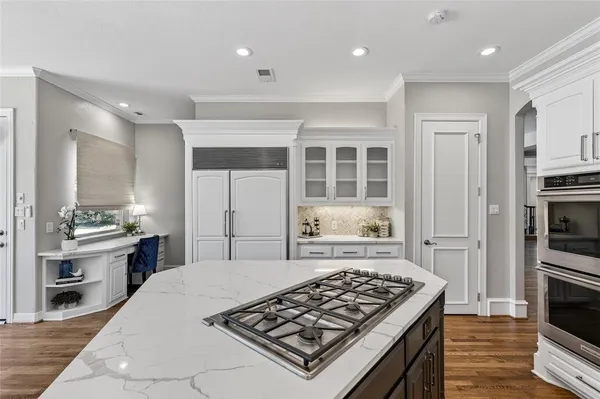 a kitchen with a stove and a refrigerator