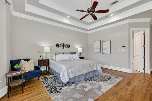 a bedroom with a large bed and a rug