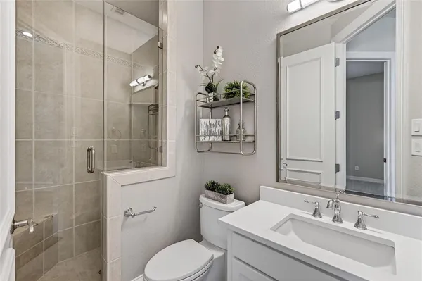 a bathroom with a sink toilet and shower