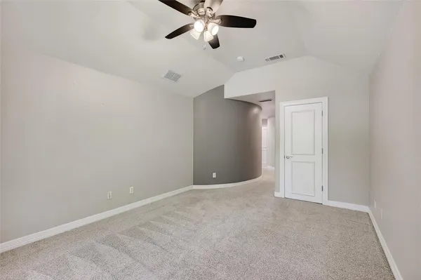 en empty room with ceiling fan and window