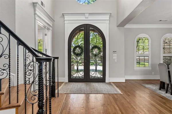 a view of front door with wooden floor and a rug