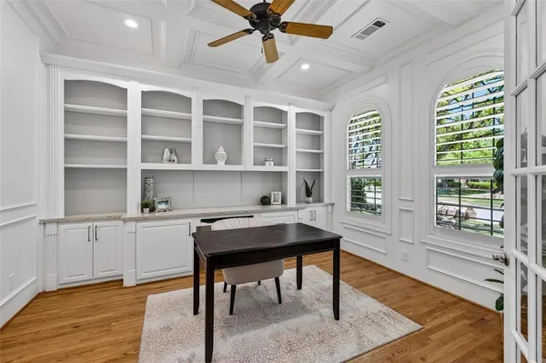 a view of a workspace with furniture and a window