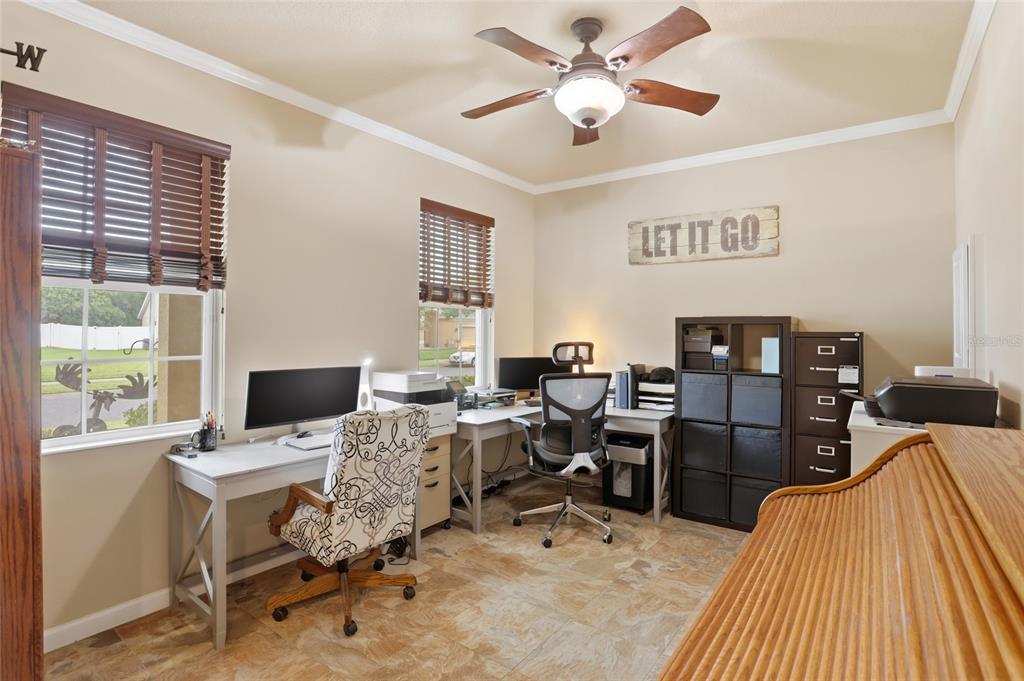 877 Haring Lane Mount Dora, FL 32757 - Photo 12 of 26 a view of a workspace with furniture and a window