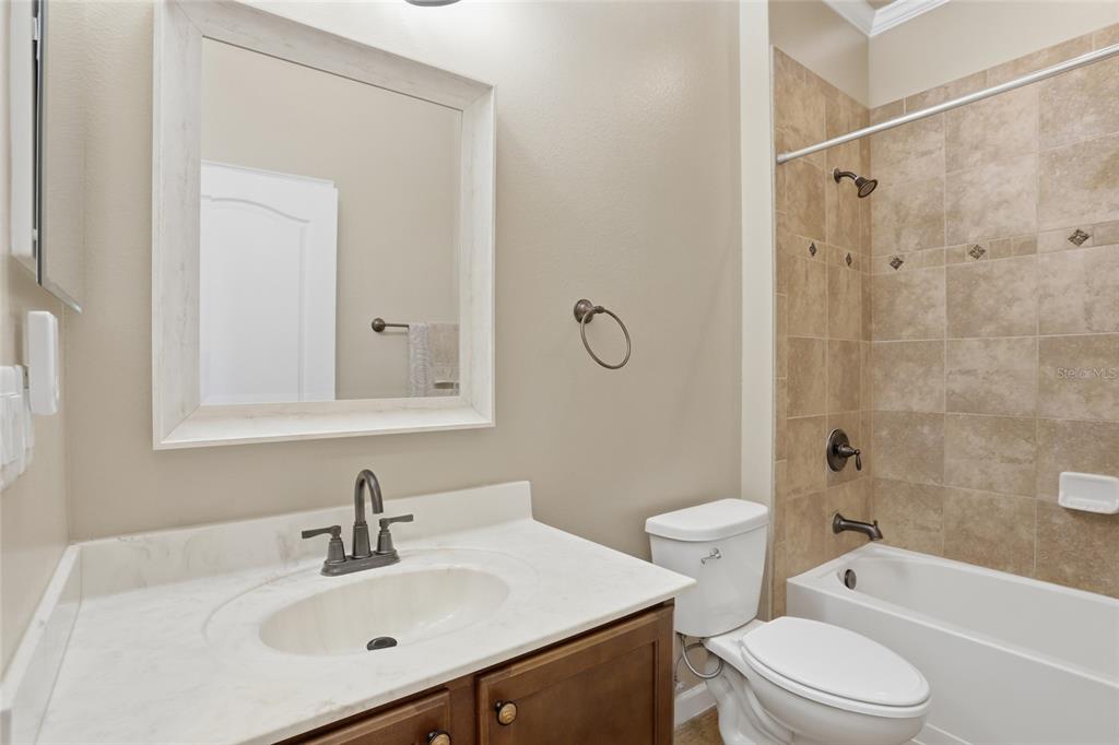 877 Haring Lane Mount Dora, FL 32757 - Photo 15 of 26 a bathroom with a sink toilet vanity and shower