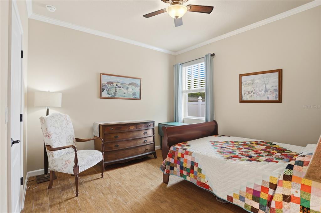 877 Haring Lane Mount Dora, FL 32757 - Photo 17 of 26 a bedroom with a bed and a chandelier