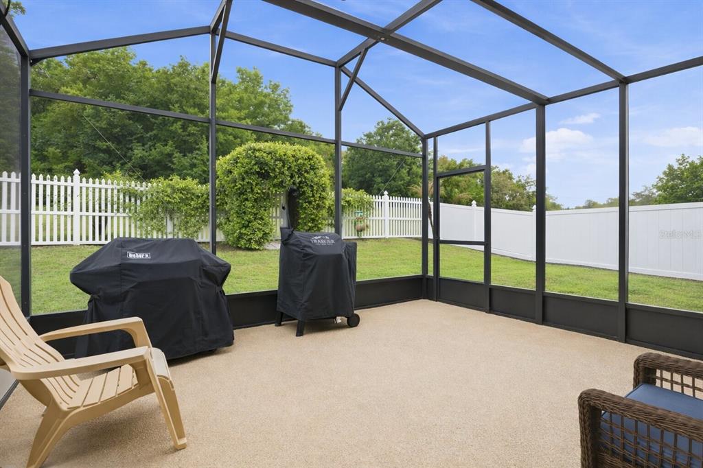 877 Haring Lane Mount Dora, FL 32757 - Photo 19 of 26 a view of a chairs and tables in the patio