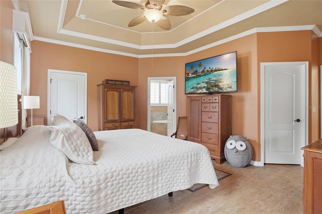 877 Haring Lane Mount Dora, FL 32757 - Photo 6 of 26 a bedroom with a bed and a chandelier