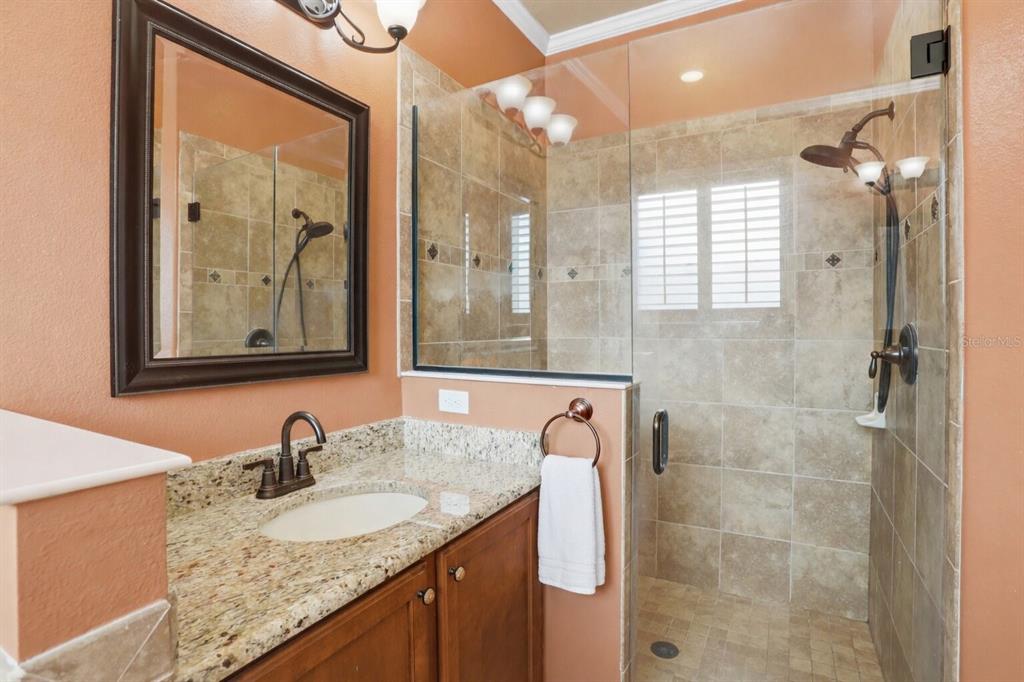 877 Haring Lane Mount Dora, FL 32757 - Photo 8 of 26 a bathroom with a granite countertop sink and a mirror