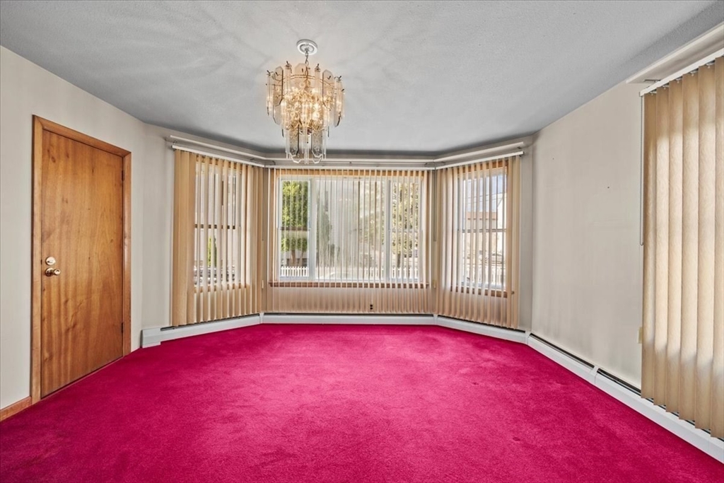 14 Grinnell Street Fall River, MA 02721 - Photo 25 of 41 a living room with furniture and a chandelier