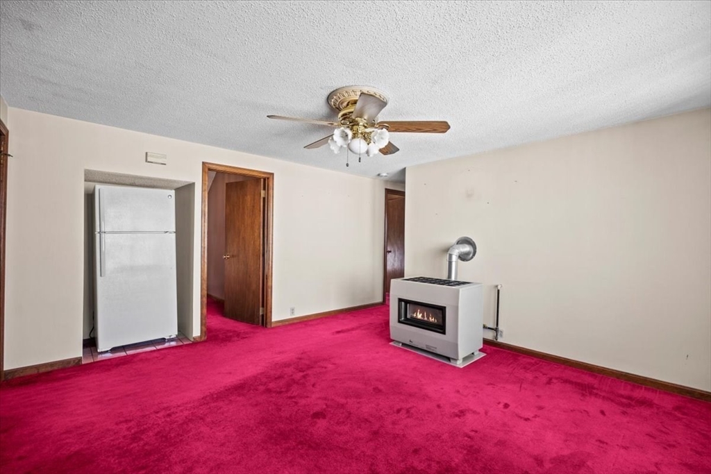 14 Grinnell Street Fall River, MA 02721 - Photo 28 of 41 a bedroom with a bed and a chandelier