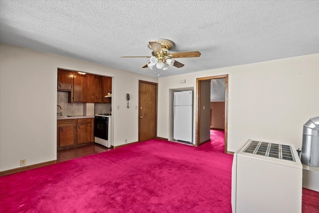 14 Grinnell Street Fall River, MA 02721 - Photo 29 of 41 a bedroom with a bed and a chandelier