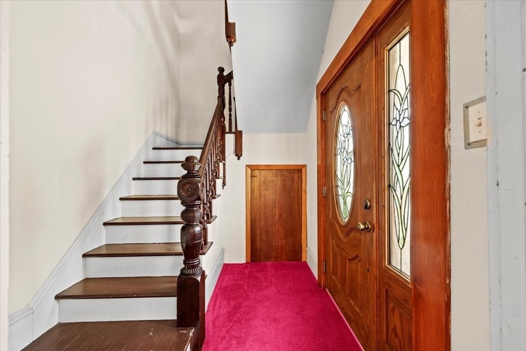 14 Grinnell Street Fall River, MA 02721 - Photo 10 of 41 a view of entryway with stairs and wooden floor
