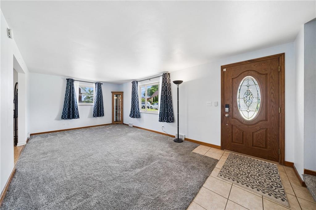 711 Jane Street Pittsburgh, PA 15239 - Photo 2 of 27 Enter into this naturally lit living room featuring brand-new carpeting and sleek tile flooring.