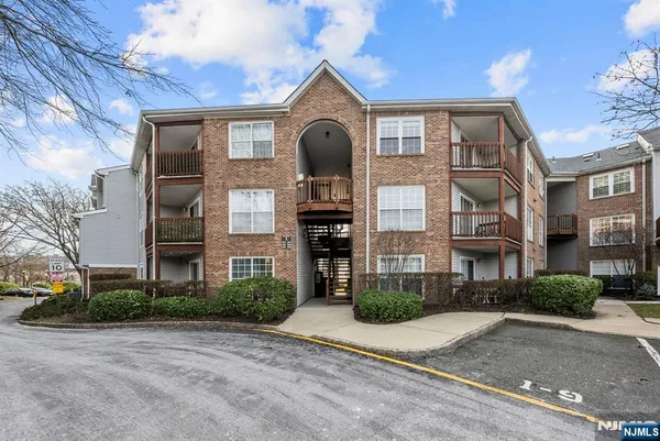 a front view of a building with a yard