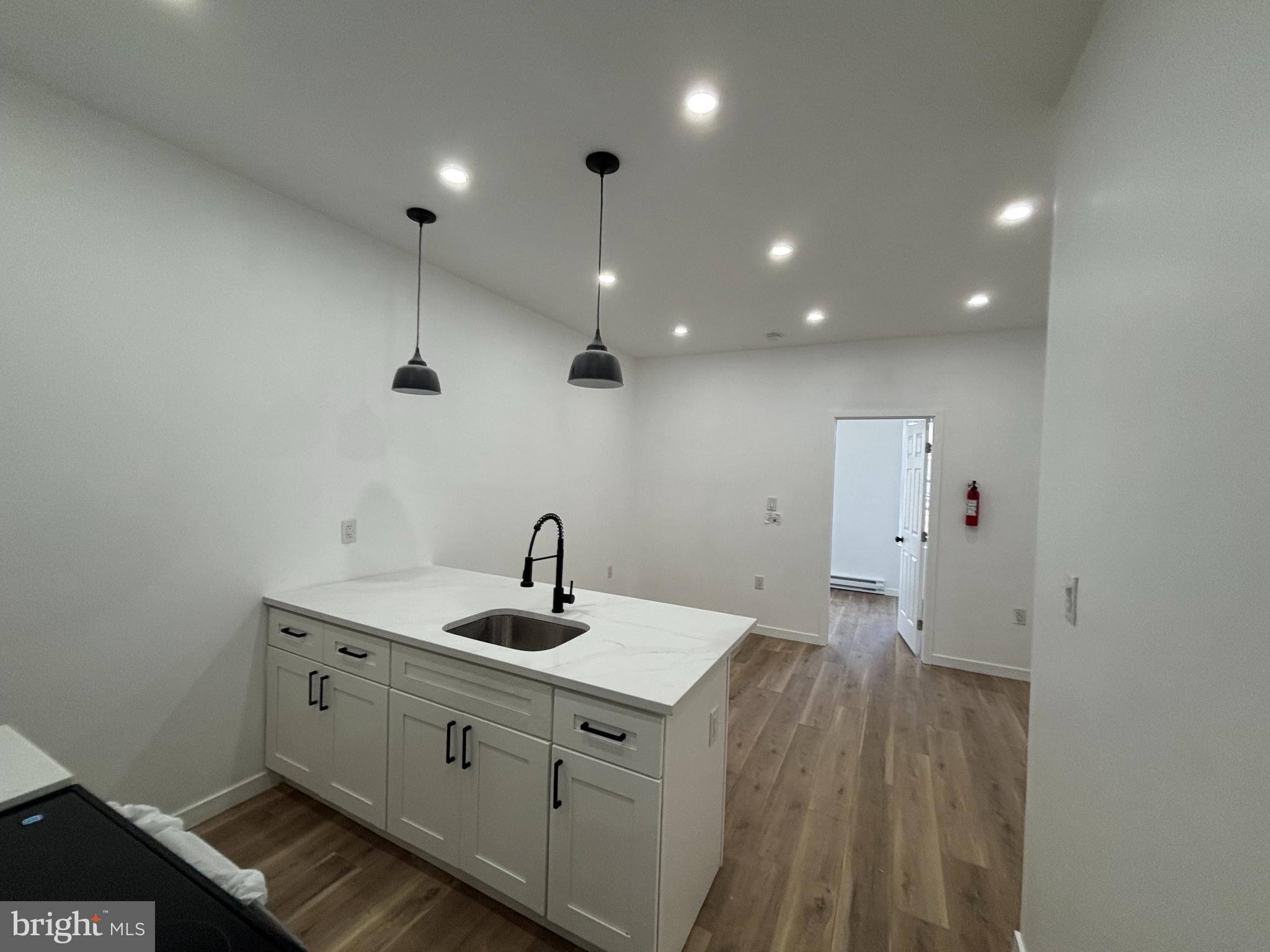 a kitchen with a sink and chandelier