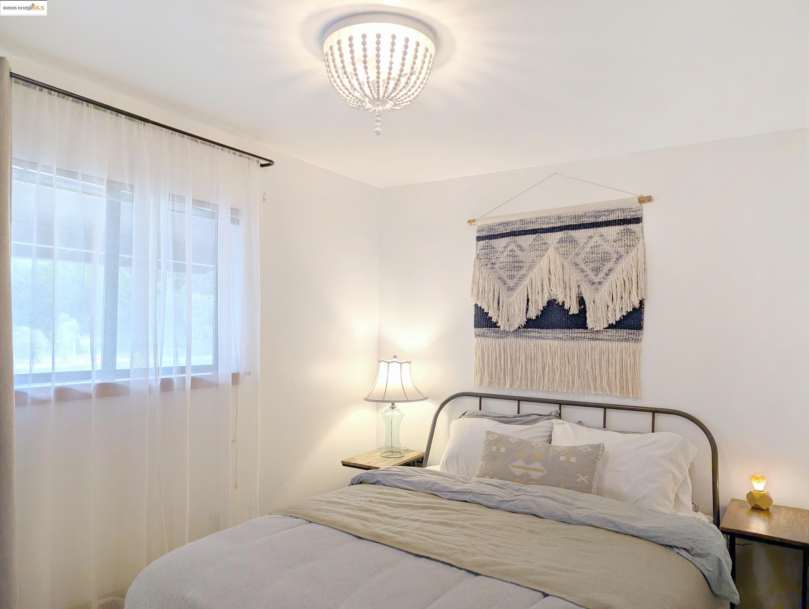 14771 Cypress Point Road Manchester, CA 95459 - Photo 11 of 36 a bedroom with a bed and a painting on the wall