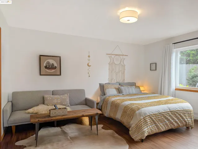 a bedroom with a bed and a couch