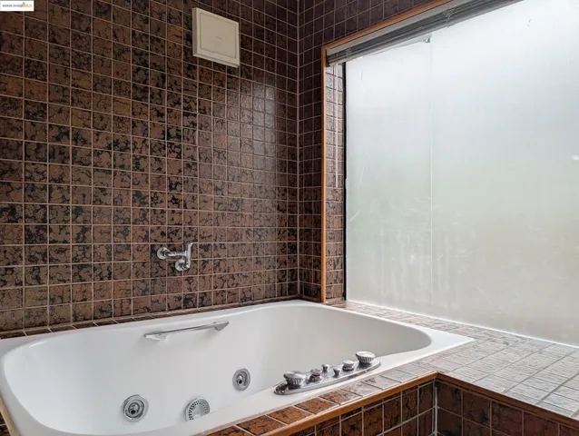 a bathroom with a tub and a shower