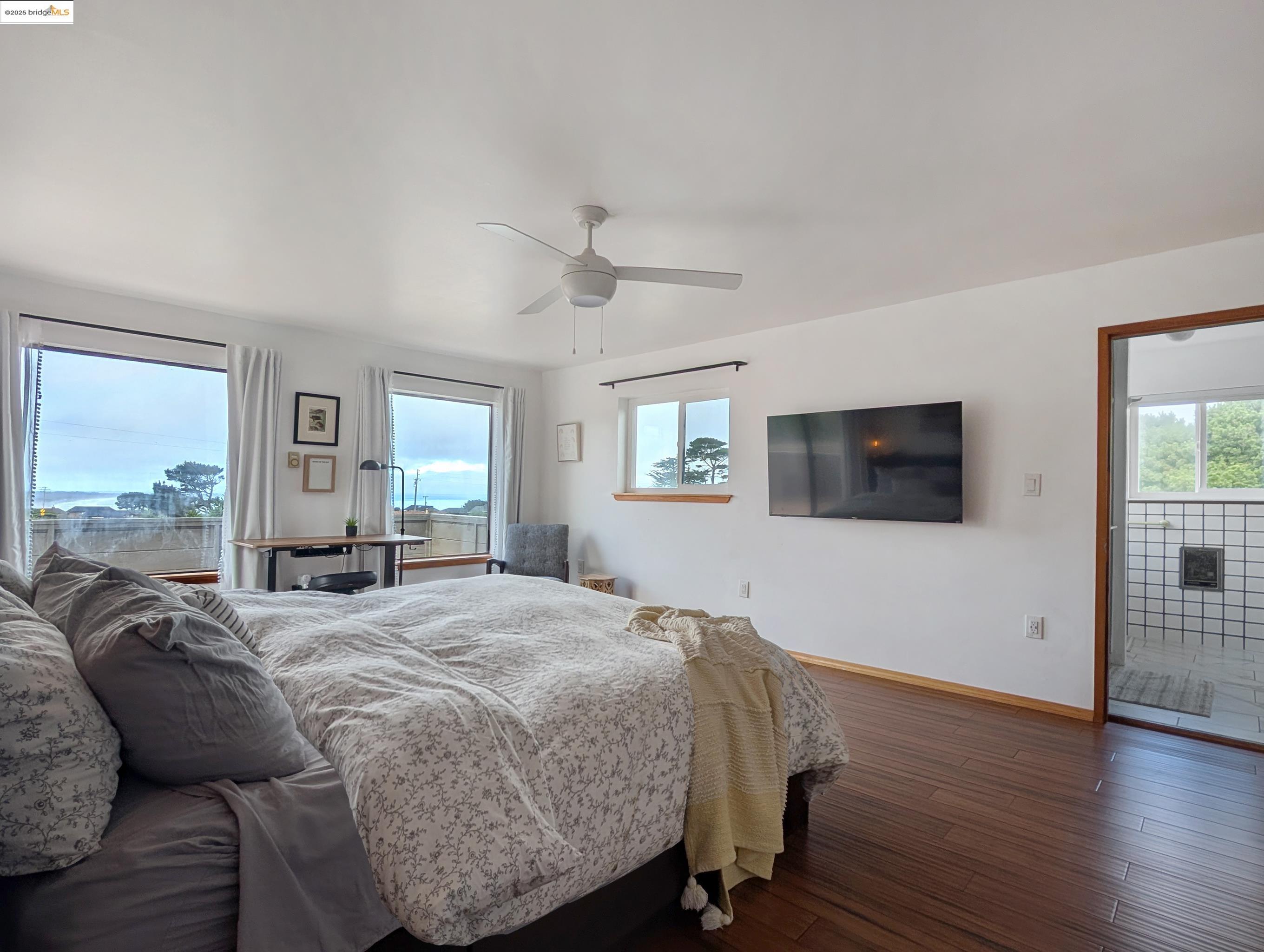 14771 Cypress Point Road Manchester, CA 95459 - Photo 18 of 36 a bed room with a bed a television and a large window