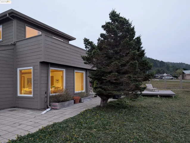 a view of house with a flower garden