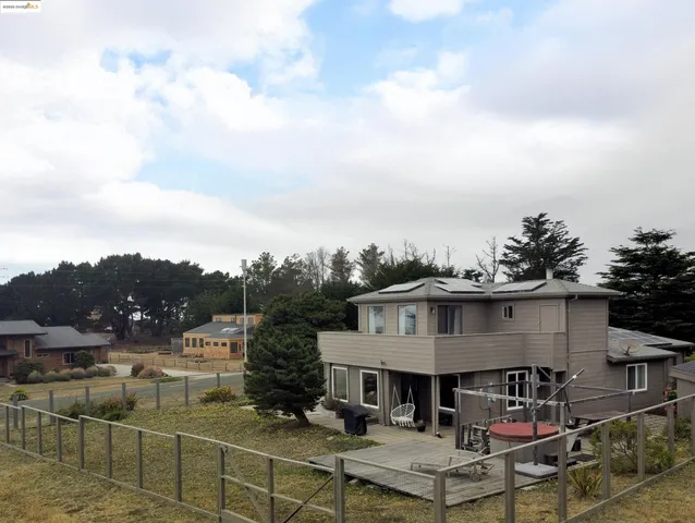 a aerial view of a house next to a yard