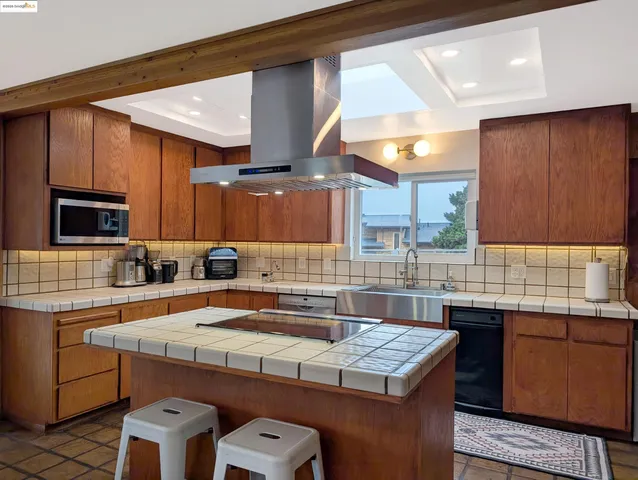 a kitchen with a sink a stove and a cabinets